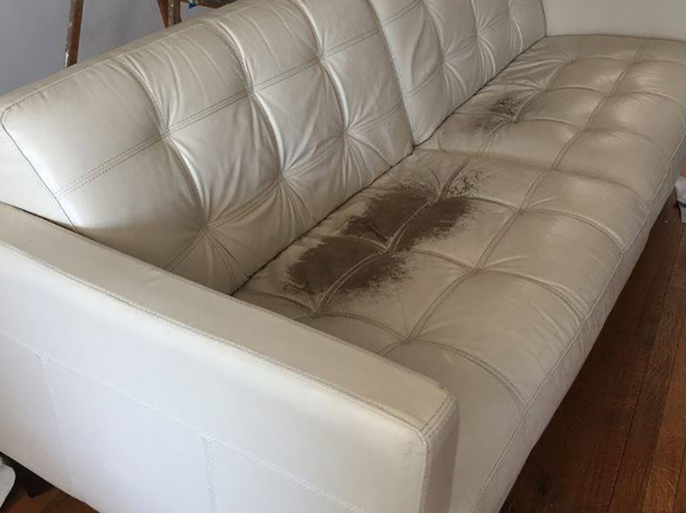 uwhite leather sofa worn